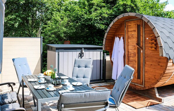 Enjoy a peaceful meal on the deck, surrounded by lush greenery.