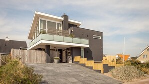 A modern two-story house with a balcony, a staircase leading to the entrance, and a paved driveway. - Awesome home in Bergen aan Zee (Bergen aan Zee)
