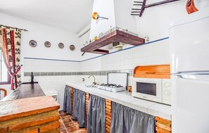 Fridge, microwave, coffee/tea maker, cookware/dishes/utensils