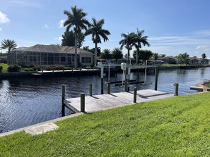 Enjoy waterfront views from the modern building with a flat roof and large windows.