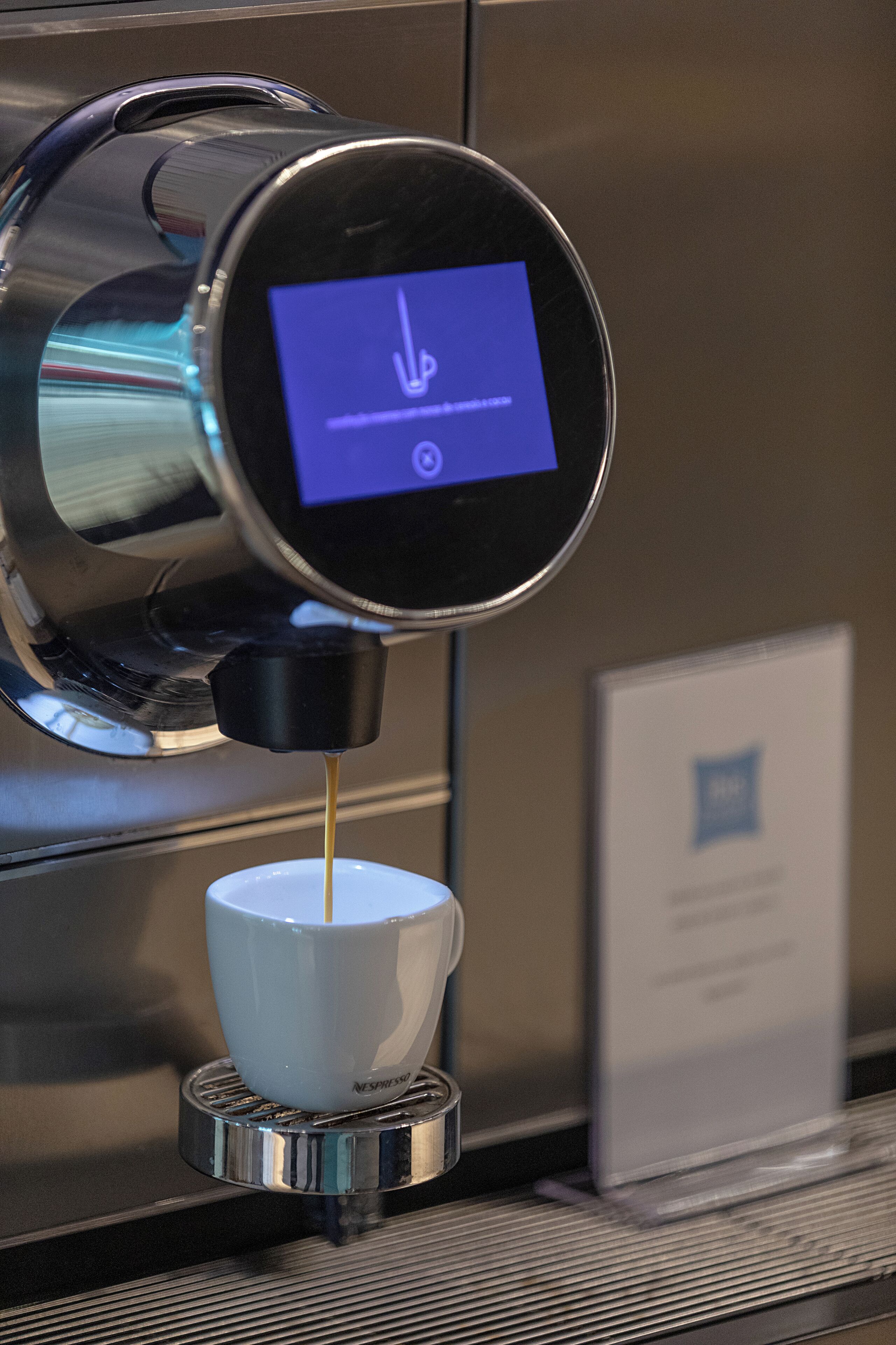 A coffee machine dispensing coffee into a cup.