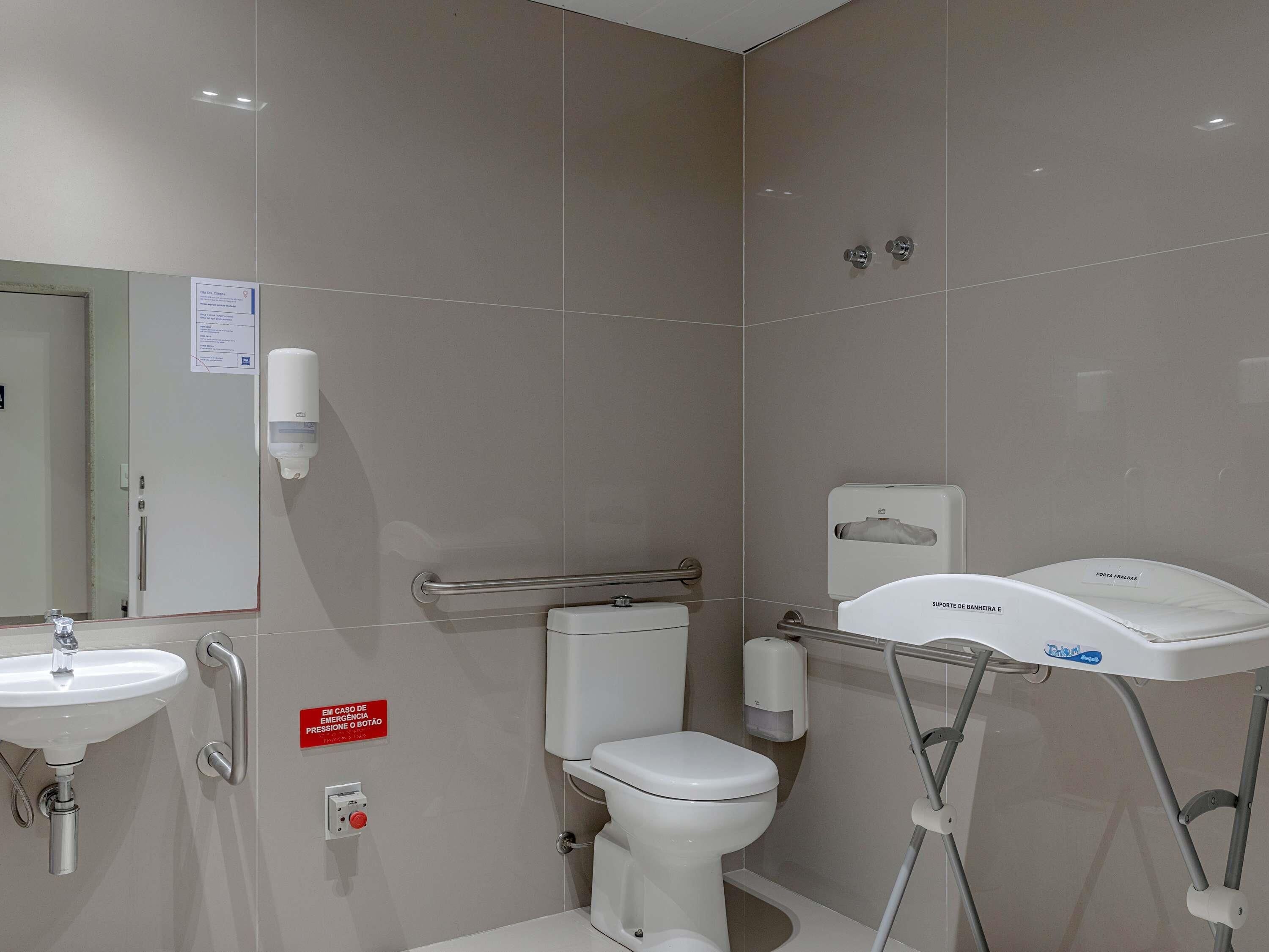 A modern bathroom with a toilet, bidet, and sink.
