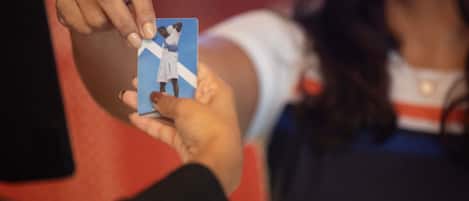 A person holding a card with a picture of a person in a white shirt.