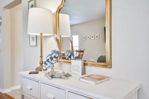 Vanity area with a large mirror, white vanity, and decorative accents.