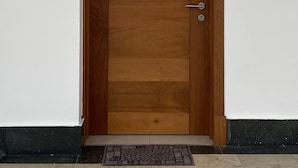 A wooden door with a keypad lock and a doorbell. - Peace In The Village, Punta Cana Village (Punta Cana)
