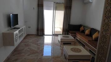 Apartment, 2 Bedrooms, Smoking, Balcony | Living area | Video game console, books
