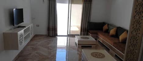 Apartment, 2 Bedrooms, Smoking, Balcony | Living area | Video-game console, books