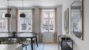 A dining area with a table, chairs, and a vase on the windowsill. - Main 1 - Cozy 2-bdr Apt in Center of Copenhagen (Copenhagen)