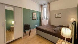 A bedroom with a bed, a desk, a chair, and a wardrobe. - Campo dei Fiori, Lovely Apartment "easy Life In Rome" (Rome)