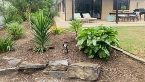 A house with a patio area featuring outdoor furniture and a pergola. - Modern country house set in the heart of the vines (McLaren Flat)