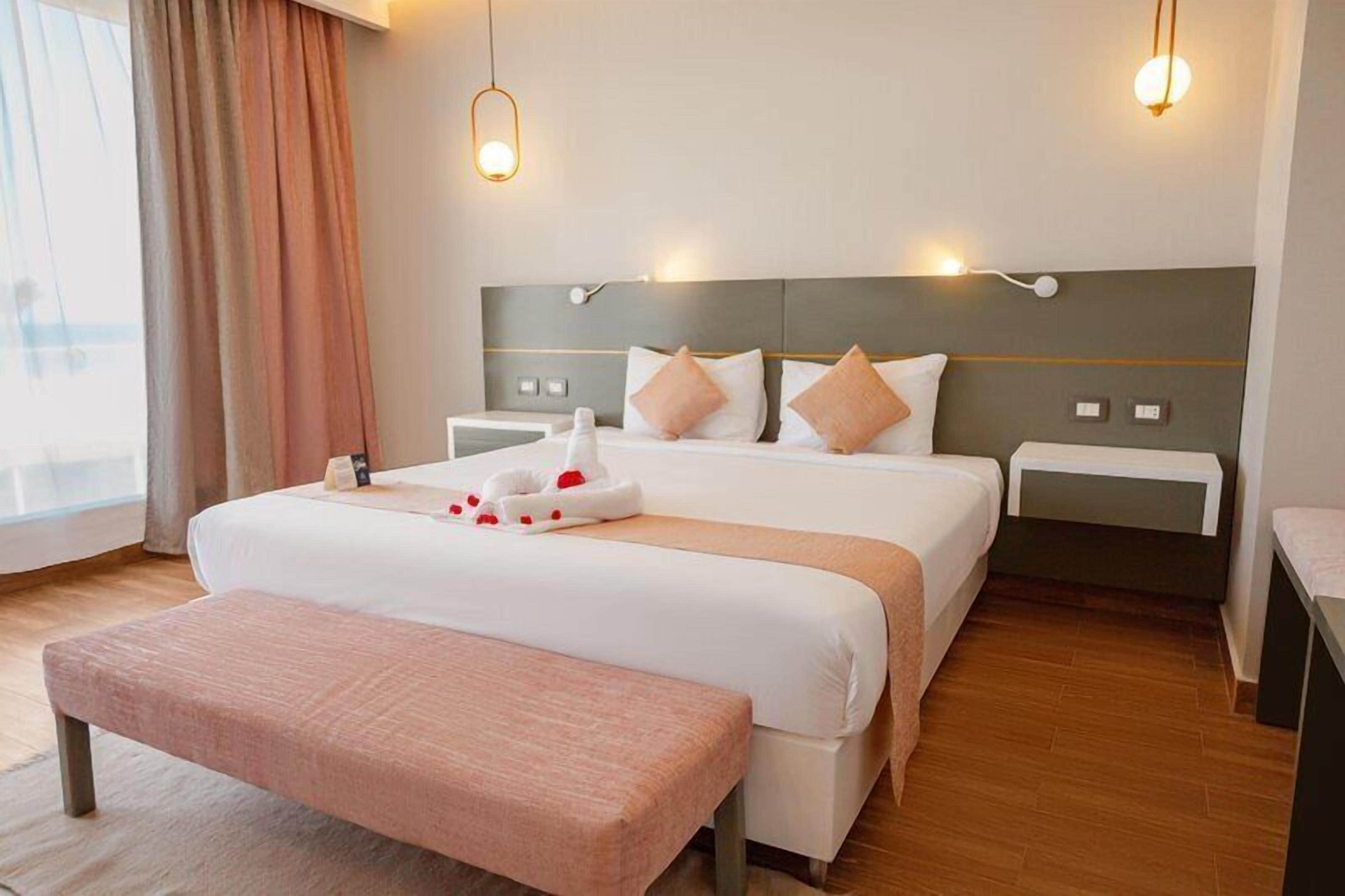 Premium Pool View | Minibar, in-room safe, iron/ironing board (on request), bed sheets
