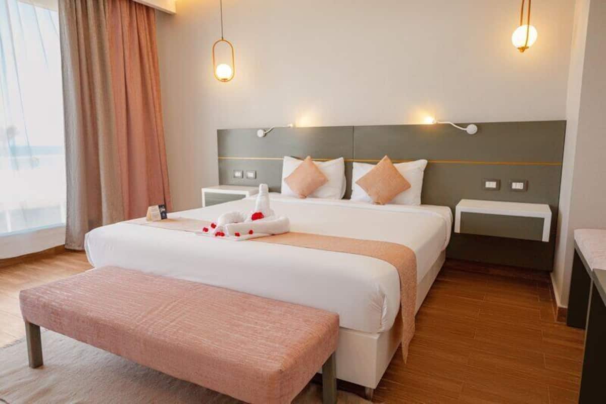 Premium Pool View | Minibar, in-room safe, iron/ironing board (on request), bed sheets