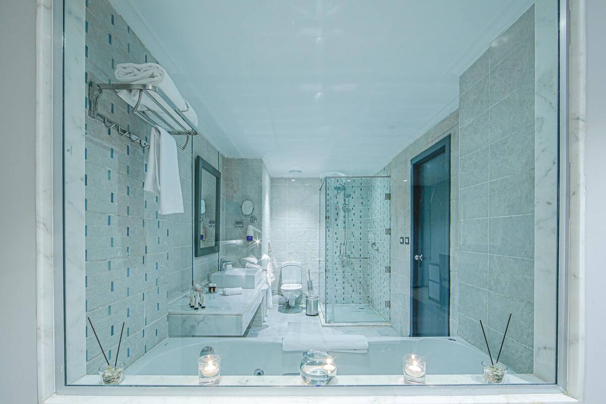 premium jacuzzi indoor | bathroom | shower, slippers, towels