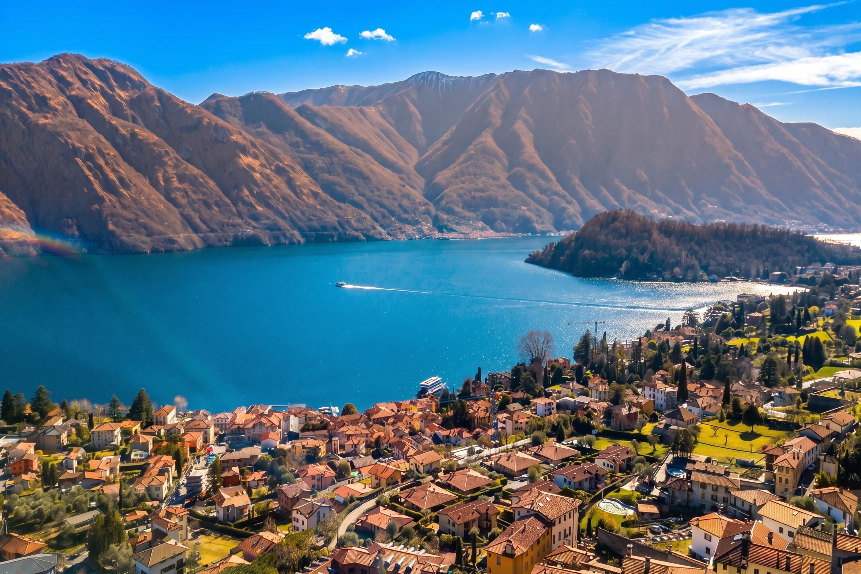 A coastal town with a view of mountains and a lake.