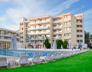 A hotel with a swimming pool, multiple balconies, and lounge chairs. - Garden Nevis - All Inclusive (Sunny Beach)