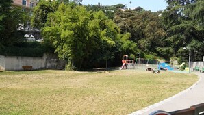 A park with a playground, benches, and a paved path. - Quiet, Clear view, Close to Beaches and Shops, Parking & Wifi Included (Menton)