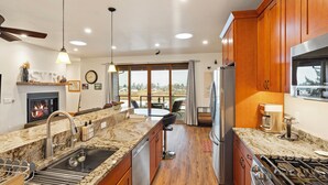 A modern kitchen with granite countertops, stainless steel appliances, and wooden cabinets. - Swan View Refuge-Luxury 2 bedroom sleeps 4 (Somers)