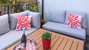 A wooden table with a checkered tablecloth, a bottle of wine, and three glasses. There is a red potted plant on the table. - 3 bedroom accommodation in Bampton, near Tiverton (Bampton, near Tiverton)