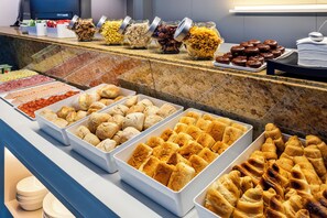 A buffet with various food items including pastries, sandwiches, and salads. - B&B Hotel e Apartamentos Felgueiras  (Felgueiras)