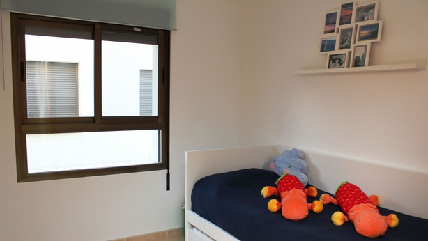 A bedroom with a bed, a window, and a wall-mounted shelf with pictures. - "Mar i Cel"@MARISOL: 220m to the beach, private pool, A/C, WiFi, dog beach. (Riumar)
