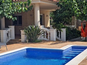 A swimming pool with a tiled edge, a brick building with a balcony, and a hammock. - "Maria Luise"@MARISOL: 600m to the beach, private pool, A/C, WiFi, dog beach. (Riumar)