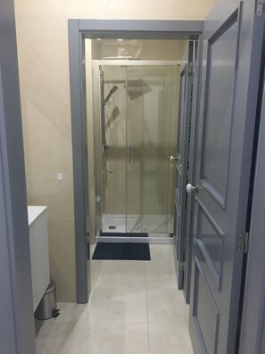 Shower, hair dryer, towels, toilet paper