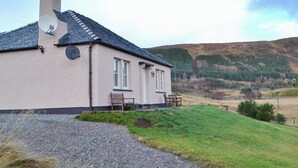 A house with a chimney, satellite dish, and two windows. - Braigh na Leitre - UK33790 (Strathconon, Muir of Ord)