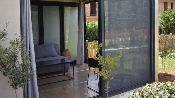 A modern room with a sliding glass door leading to a patio area.