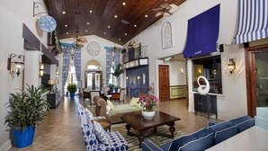 A spacious lobby with a high ceiling, wooden beams, and a central seating area with sofas and a coffee table. - Disney 10mins, Free heated Private Pool, Security Gated, Luxury stay in Orlando (Kissimmee)