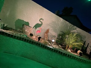 Stroll through the beautifully landscaped area, featuring a unique flamingo sculpture and other decorative elements.