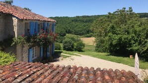 A rustic house with a tiled roof and a garden with a gravel path. - Demeure de Charme 10 Personnes Avec Piscine (Sainte-Colombe-en-Bruilhois)