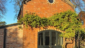 A brick building with a large arched window and a circular window above it. - Southfield Art Studio (Braunston, near Daventry)
