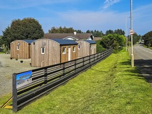 A wooden holiday hut with a sign indicating it is a holiday hut.