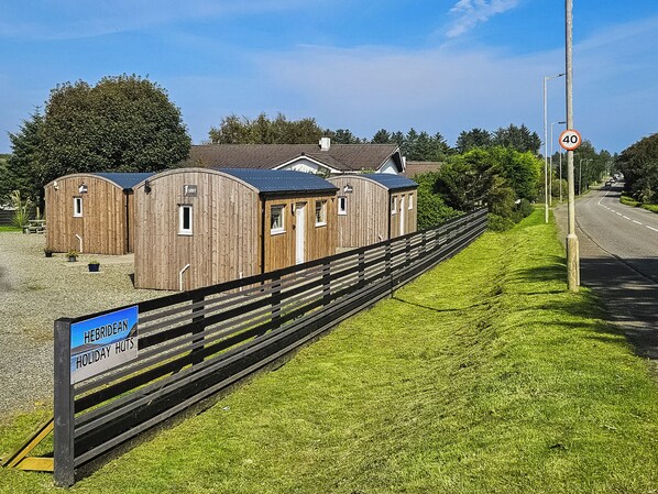 A wooden holiday hut with a sign indicating it is a holiday hut.