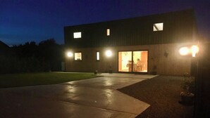 A modern building with a large driveway, a visible entrance, and a well-lit interior. - 5 bedroom accommodation in Somerton (Somerton)