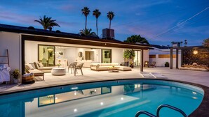 A modern house with a swimming pool, outdoor seating, and palm trees. - Scottsdale Luxury Escape (Scottsdale)
