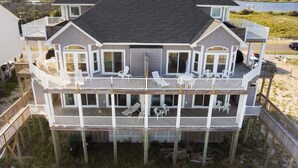 A multi-level waterfront house with balconies, outdoor seating, and a view of the water. - 6 BR/5.5 baths on quiet beach.  Penthouse suite.  Free linens.  Gorgeous views! (North Topsail Beach)