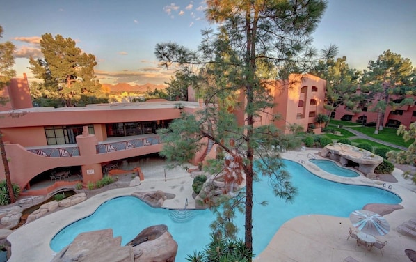 A resort with multiple swimming pools, a central courtyard, and a building with balconies. - Ground floor golf course view, quiet updated 2 BR 2 BA condo, summer discount! (phoenix)