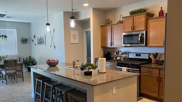 A modern kitchen with granite countertops, stainless steel appliances, and wooden cabinets. - NEW!!! Spring Break Getaway <br>At Mountain Side Retreat (Buckeye)