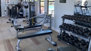 A gym with various exercise equipment, including treadmills, weight machines, and dumbbells. - NEW!!! Spring Break Getaway <br>At Mountain Side Retreat (Buckeye)
