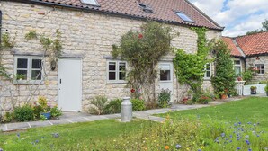 A stone building with a tiled roof, a small window, and a door. - 3 bedroom accommodation in Little Edstone, near Pickering (Little Edstone, near Pickering)