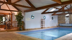 An indoor swimming pool with wooden beams, exercise equipment, and a sign indicating supervision for children. - 3 bedroom accommodation in Little Edstone, near Pickering (Little Edstone, near Pickering)