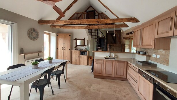 A kitchen with wooden cabinets, a dining table with chairs, a ceiling fan, and a staircase leading to an upper level. - Bergerie du Mas de Darre (with spa, terrace and garden) between Lot and Aveyron. (Sainte-Croix)