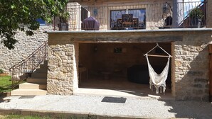 A stone building with a balcony, a staircase, and a hammock. - Bergerie du Mas de Darre (with spa, terrace and garden) between Lot and Aveyron. (Sainte-Croix)