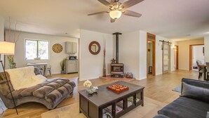 A spacious living room with a fireplace, a ceiling fan, and a dining area. - Peaceful Sedona retreat with red rock views, walk to Sedona Golf Resort (Sedona)