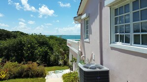 A house with a view of the ocean, a balcony, and an air conditioning unit. - Private Waterfront  Home With 180* Sea Views - 2 Bed / 2Bath (Spanish Wells)