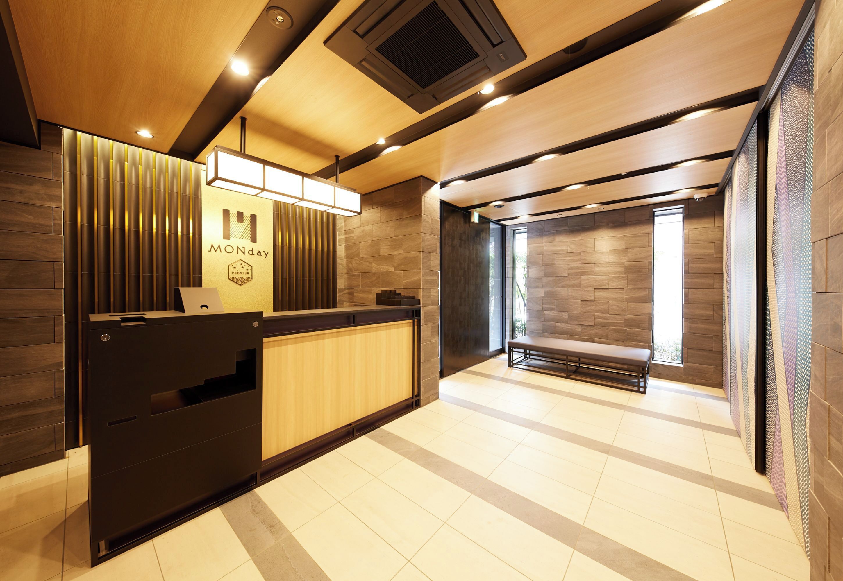 A reception area with a wooden reception desk, a bench, and a wall with vertical slats.