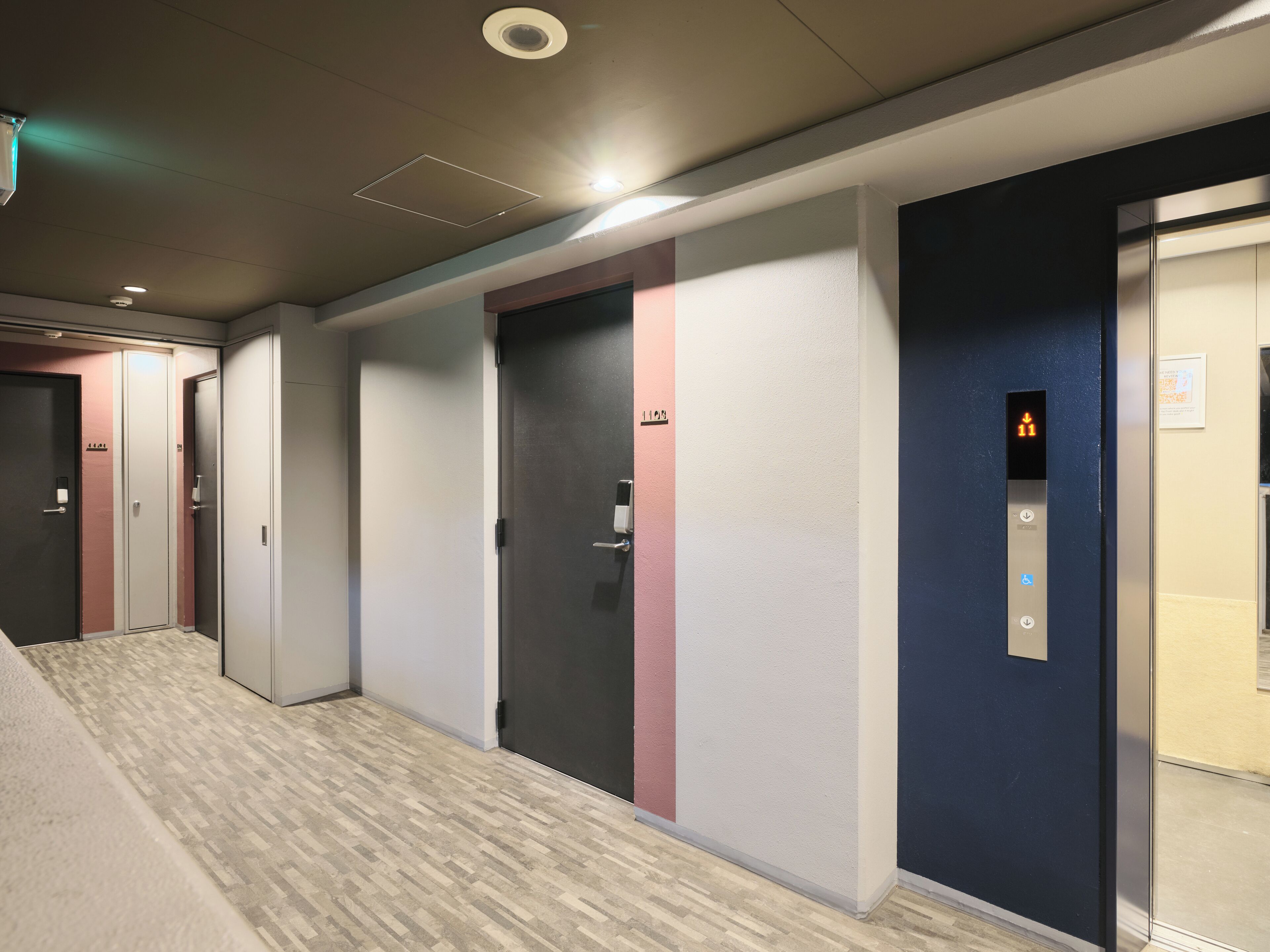A hallway with multiple doors, some with numbers and others with symbols, leading to different rooms.