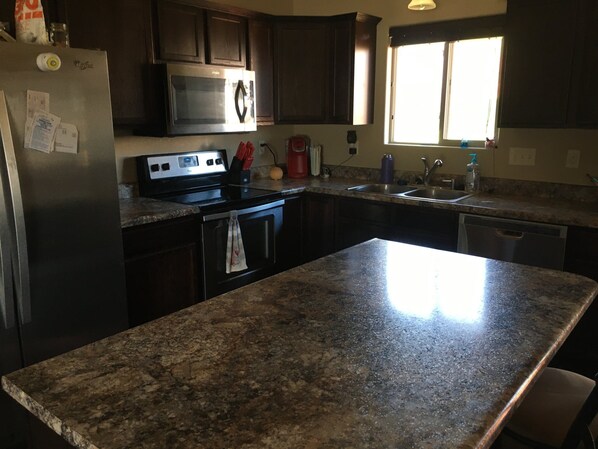 Enjoy cooking in this well-equipped kitchen with a double sink, microwave, and dishwasher.