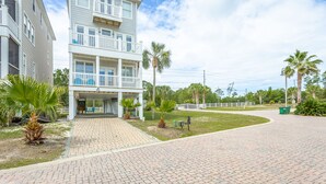 A two-story building with a covered porch and a paved driveway. - Fish, Beach, Pool, Swim, Relax in Luxury Rent for the month only 5,900.00 (Carrabelle)